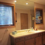 Bathroom with large wall mirror